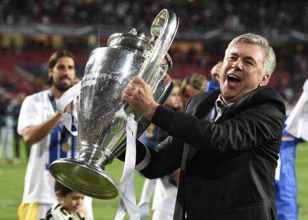 Carlo Ancelotti football coaches with the most trophies Real Madrid's Italian coach Carlo Ancelotti celebrates their victory with the trophy at the end of the UEFA Champions League Final Real Madrid vs Atletico de Madrid at Luz stadium in Lisbon, on May 24, 2014. Real Madrid won 4-1. AFP PHOTO/ FRANCK FIFE (Photo by Franck FIFE / AFP) 