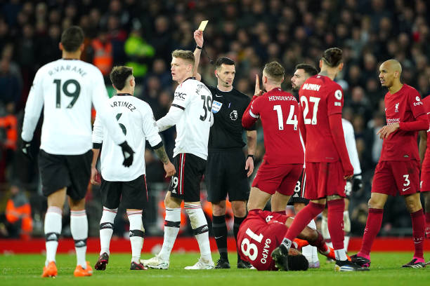 Manchester United vs. Liverpool best soccer rivalries Referee Andrew Madley shows a yellow ard to Manchester United's Raphael Varane (left) for a foul during the Premier League match at Anfield, Liverpool. Picture date: Sunday March 5, 2023.