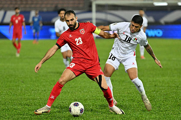 Palestine's Jonathan Cantillana (R) tries to tackle Jordan's Ihsan Haddad (C) during the 2026 FIFA World Cup Asian qualification football match between Jordan and Palestine at Kuala Lumpur Stadium in Kuala Lumpur on September 10, 2024.