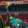Senegal's forward #10 Sadio Mane holds up the trophy as he celebrates with his teammates after winning the Africa Cup of Nations (CAN) final football match against Morocco at the Prince Moulay Abdellah Stadium in Rabat on January 18, 2026.