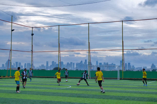 Members of an amateur football club play mini soccer on the rooftop of a traditional market building in Jakarta, Indonesia, on March 9, 2025. The growing trend of sports and healthy lifestyles in major Indonesian cities, especially Jakarta, has driven the expansion of sports facilities and infrastructure. Several old buildings, including previously vacant traditional markets, have been renovated and converted into mini soccer, futsal, and badminton courts.