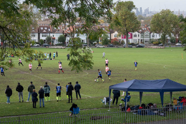 How to Organise a Weekly Football Game With the city in the distance, amateur football players play a match in a Spanish-speaking league at Ruskin Park, a public green space in Lambeth south London, on 28th October 2023, in London, England. (Photo by Richard Baker / In Pictures via Getty Images)